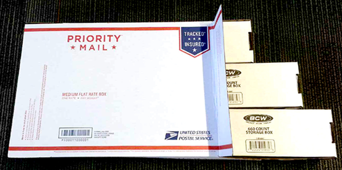 A USPS medium flat rate box with BCW storage boxes inside.